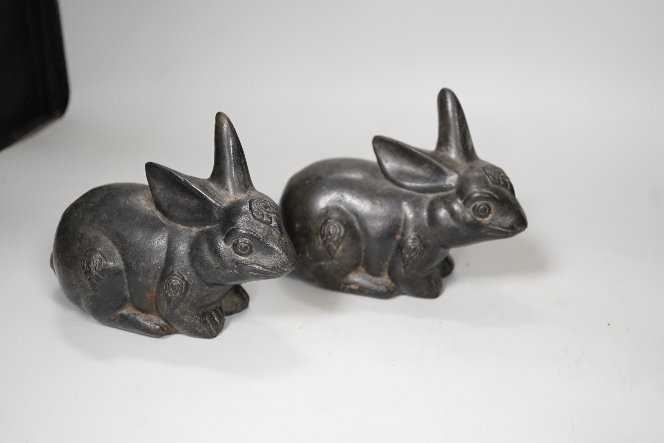 A pair of Chinese bronze models of rabbits, together with two vases and a dragon seal. Tallest 16cm